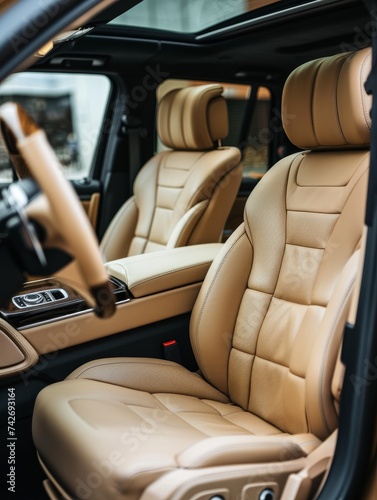Natural light floods the interior of an upscale vehicle, showcasing the rich tan leather seats and high-quality materials, a testament to luxury and comfort in modern car design. © Artsaba Family