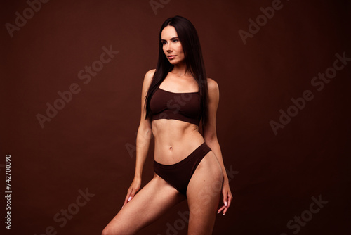 Photo of adorable confident girl no filter flawless smooth skin stylish top comfortable panties isolated on brown color background © deagreez