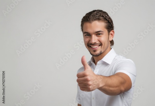 A smiling man with tied-back hair gives a thumbs up, expressing positivity and confidence.