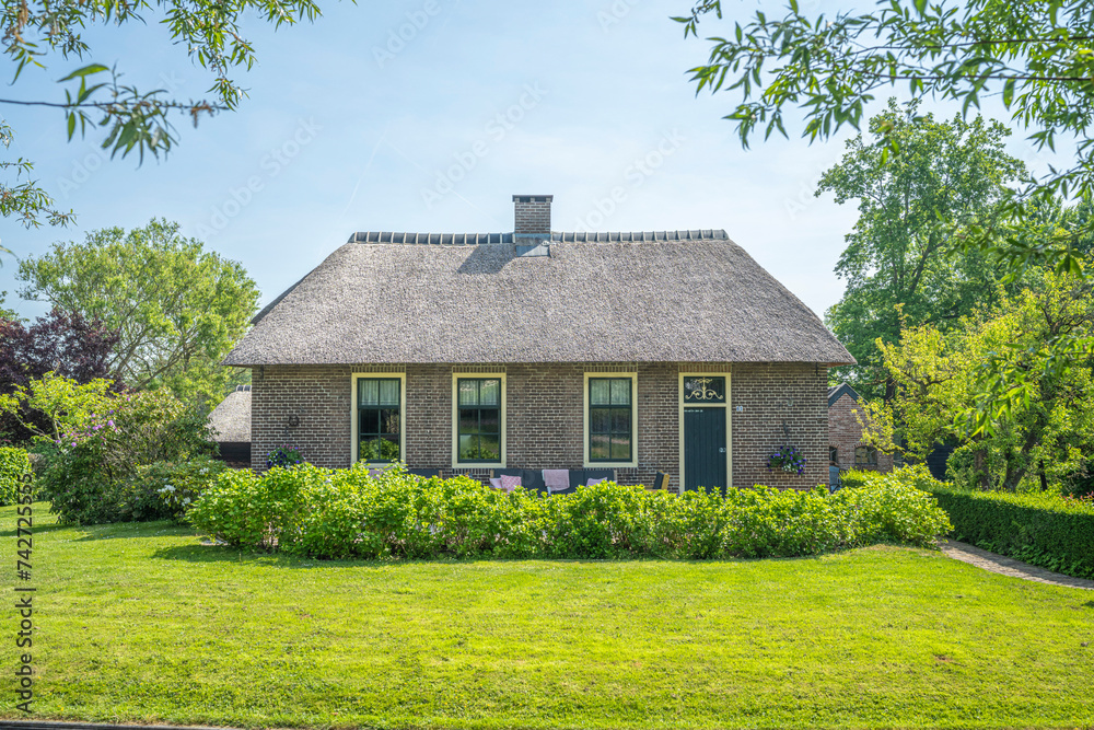 Traditional dutch house with a thatched roof in the Netherlands.
