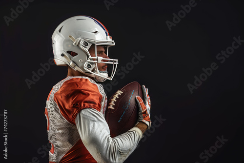 Portrait American football sportsman player on black background