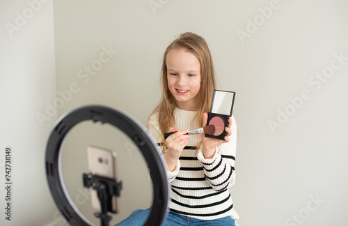 Little blond girl blogger filming new video, makeup beauty blog channel 