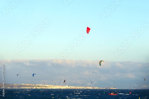 view over the Atlantic Ocean with many kitesurfers with Tarifa and Morocco on the horizon, Strait of Gibraltar, Andalusia, Spain photo