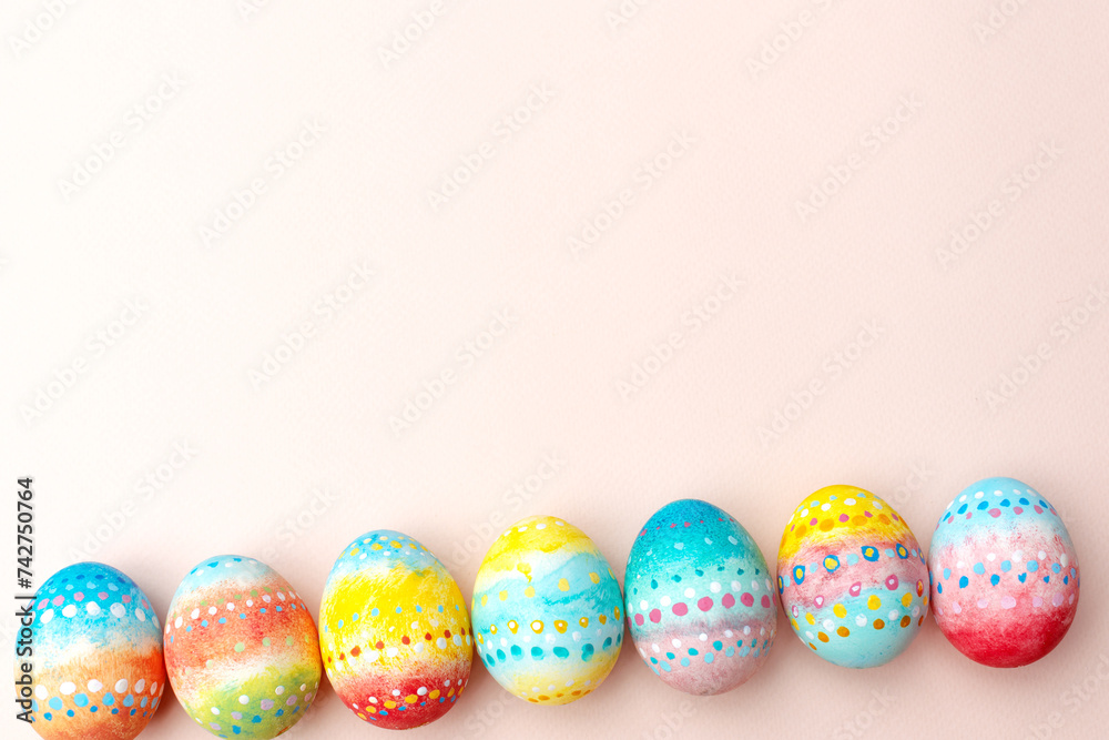 Easter background. Handmade painted eggs lie on a pink background. Easter background. Handmade painted eggs lie on a pink background.