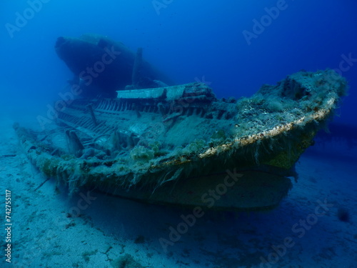 wreck underwater shipwreck on seabed sea floor standing metal on ocean floor some fish around