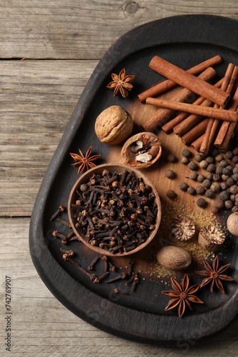 Different spices on wooden table, top view
