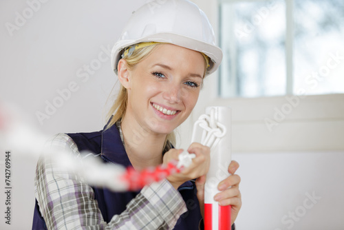 female builder cordonning off a work site photo