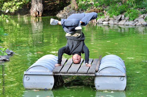 A young acrobatic dancer dances in nature