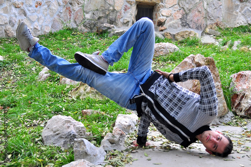 A young acrobatic dancer dances in nature