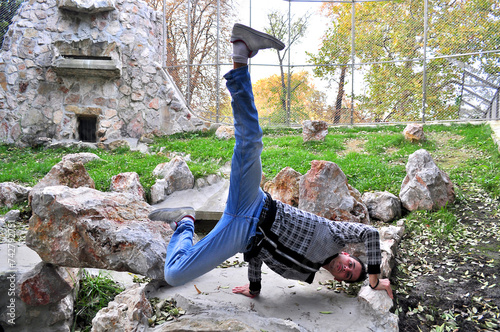A young acrobatic dancer dances in nature