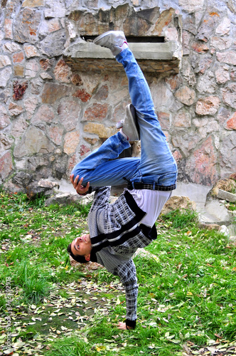 A young acrobatic dancer dances in nature