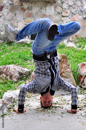 A young acrobatic dancer dances in nature