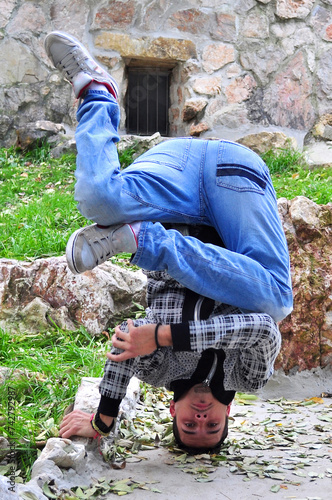 A young acrobatic dancer dances in nature