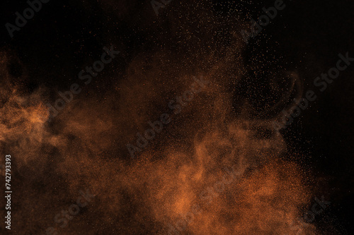 Orange powder explosion on black background. Flame cloud. Yellow dust explode. 
