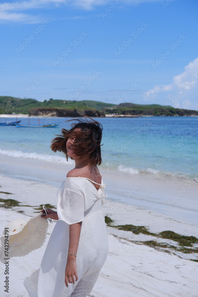 A beautiful asian woman running on the beach
