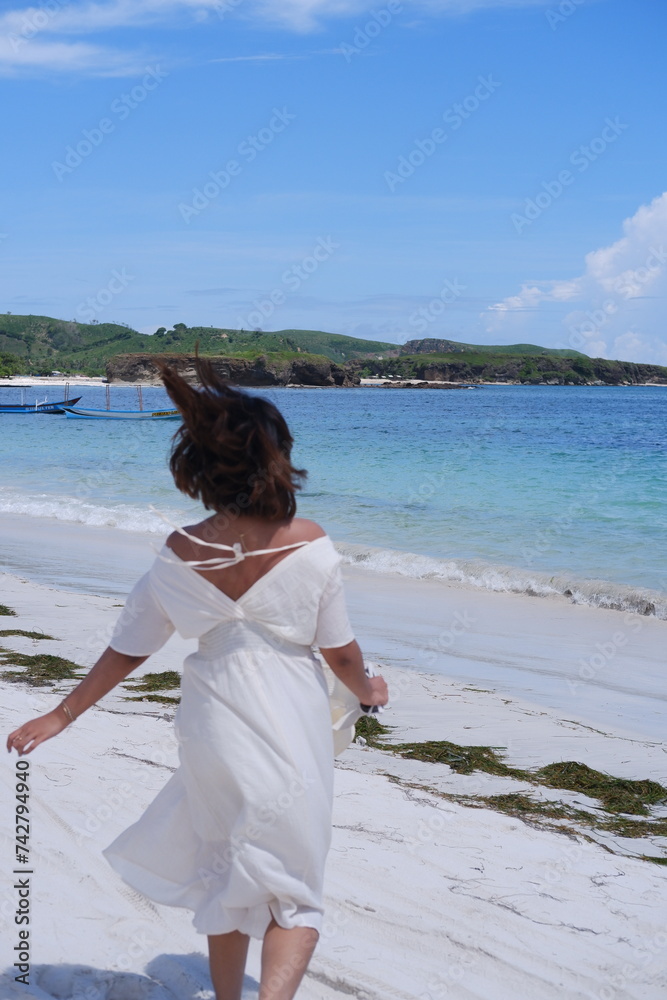 A beautiful asian woman running on the beach A beautiful asian woman running on the beach