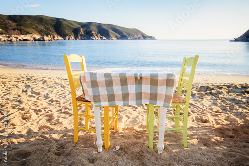 Greek taverna table at sand beach.