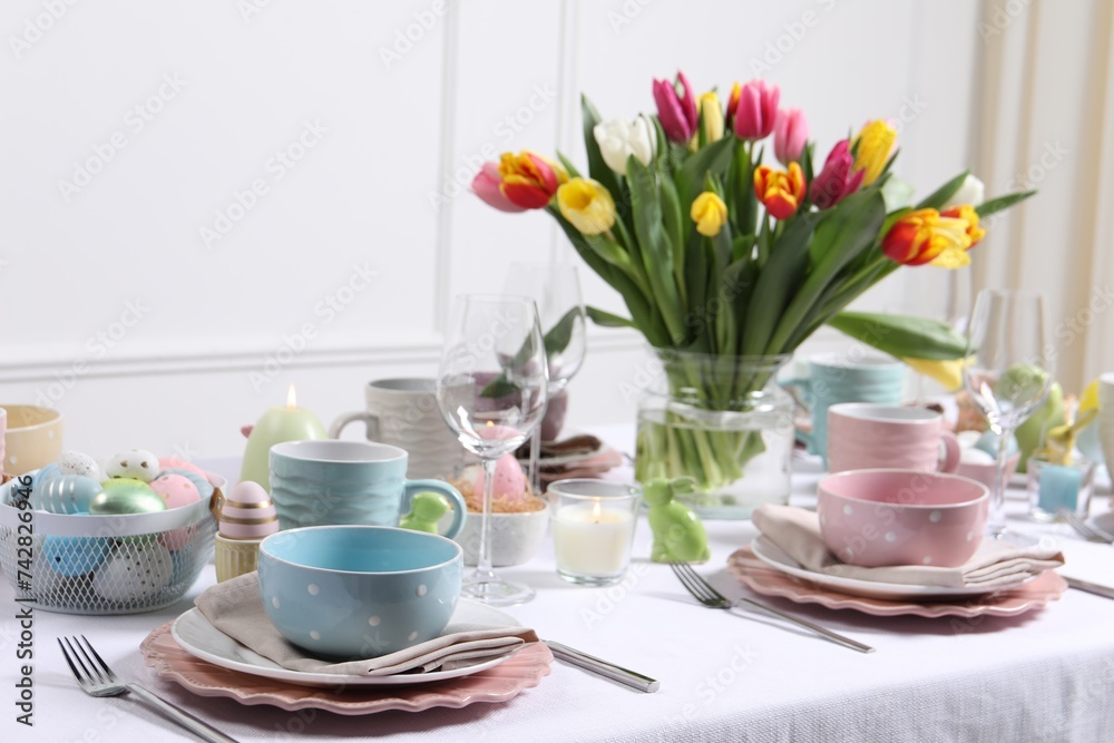 Festive table setting with beautiful flowers. Easter celebration