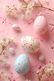 Colored Easter eggs with spring flowers on a soft pink pastel background