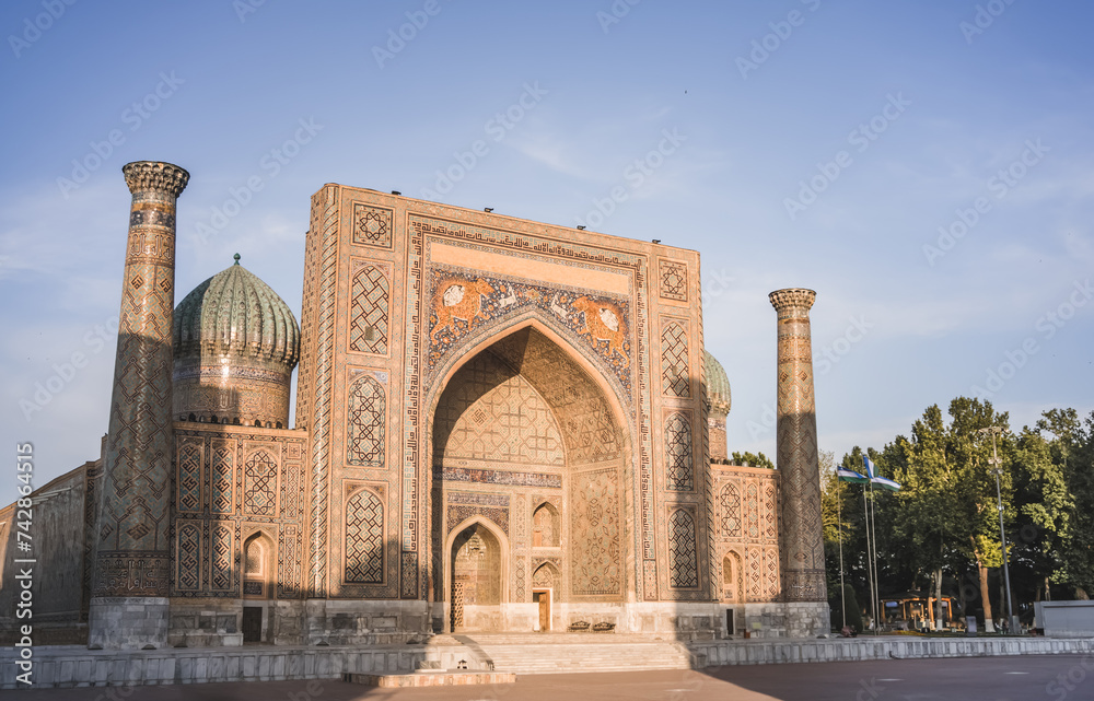Eastern architecture of buildings, madrasahs, mausoleums and mosques made of brick and mosaic cladding on the facades in the ancient city of Samarkand in Uzbekistan