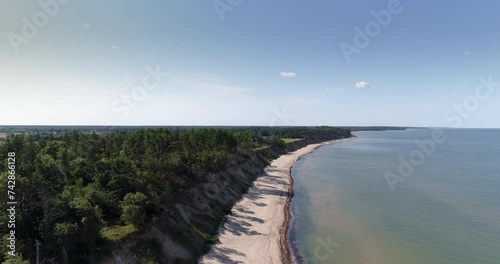 Aerial drone shot of white sand beach and seashore bluffs in Jūrkalne, Latvia photo