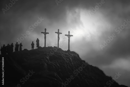 three crosses on top of hill stand against a darkening sky. photo