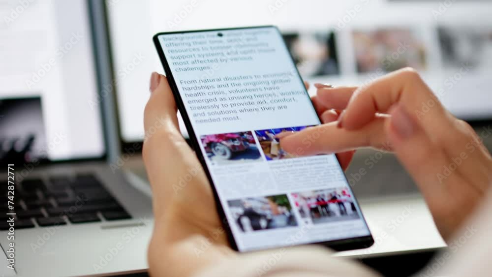 Watching Online News Article On Mobile Phone And Laptop Watching Online News Article On Mobile Phone And Laptop