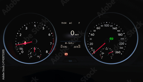 Inside the car. Speedometer scoring low speed on black background. Automobile