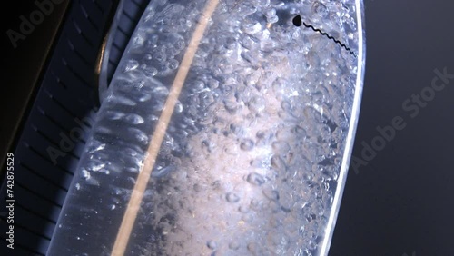 Soda maker, carbonation machine or Sparkling water makers. Putting stream of bubbles into water bottle. 