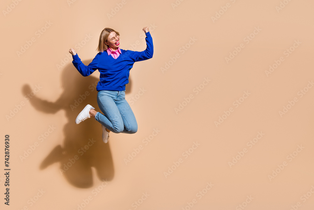 Full length photo of success in career woman celebrate first extra bonus profit empty space company isolated on beige color background