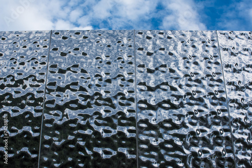 Metal building facades that mimic the texture of rippling water surfaces