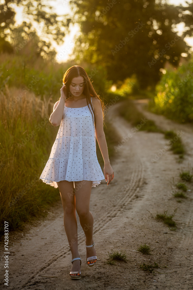 Young beautiful woman in white dress in corn field. Young beautiful woman in white dress in corn field.