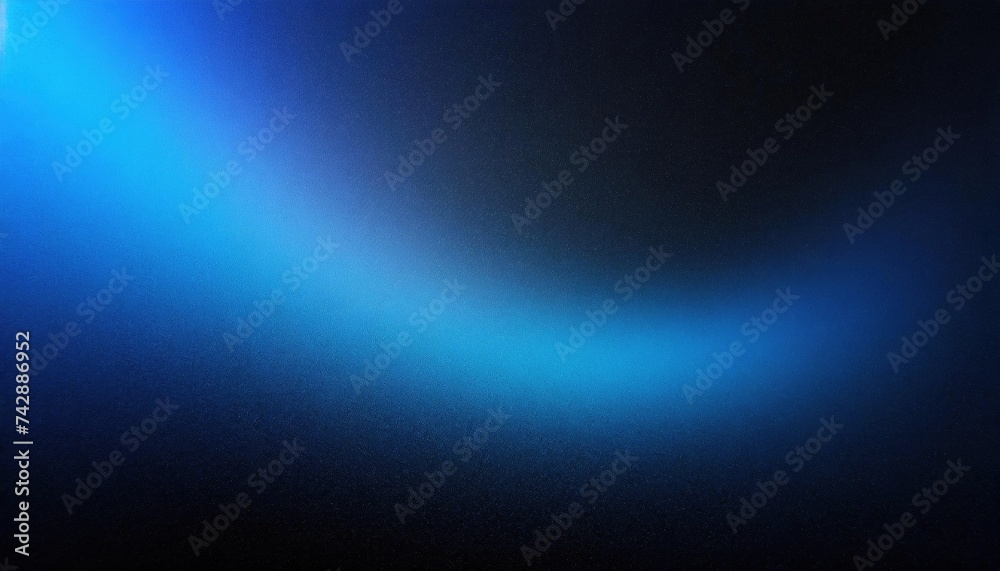 A gradient of blue light on a textured black background, abstract and atmospheric.