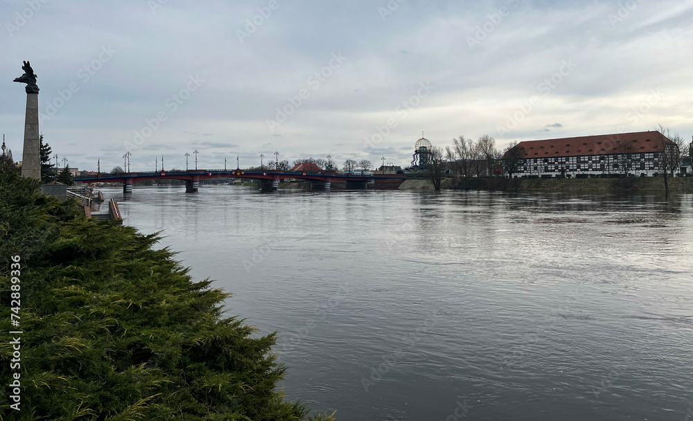 Poland, Gorzow Wielkopolski, 18 February 2024: View of the Warta River, bridge White Barn - a monument of the 18th century, now a branch of the Lubusz Museum. Warta River flood. Flooded shores.
