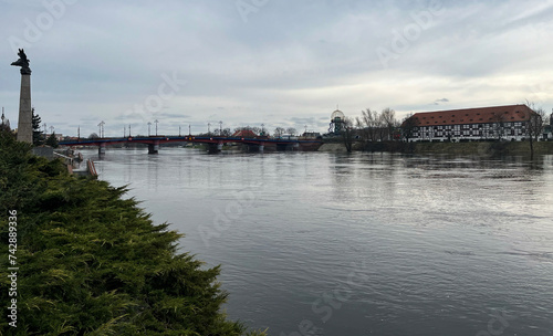 Poland, Gorzow Wielkopolski, 18 February 2024: View of the Warta River, bridge White Barn - a monument of the 18th century, now a branch of the Lubusz Museum. Warta River flood. Flooded shores.  © fotorybalka