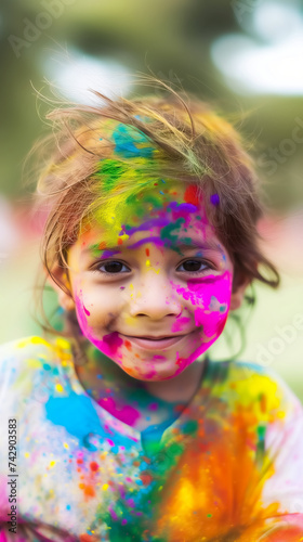 cute little girl covered in colorful vibrant holi colors hindu festival celebration