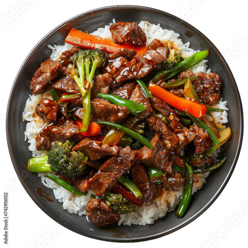 Mongolian beef stir-fry, featuring thinly sliced beef stir-fried with vegetables in a savory sauce, served over steamed rice.