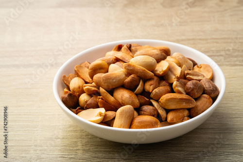 Close up Air fryer Roasted peeled peanuts in white plate.rich in protein,fat,and fiber