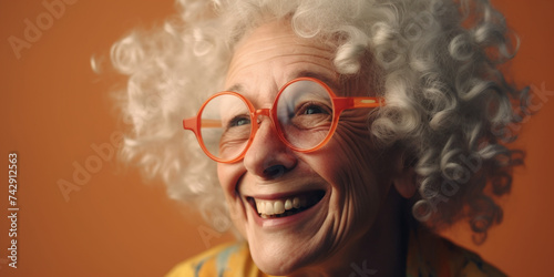 Cheerful grandmother with gray curly hair laughs and smiles