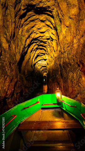 Cave. Dungeon. Silesia. Silver rush. Swimming along underground rivers. Tarnowskie Góry. Black Trout Adit. Miners of Silesia. The boat is underground. Underground river. River in a cave. UNESCO. photo