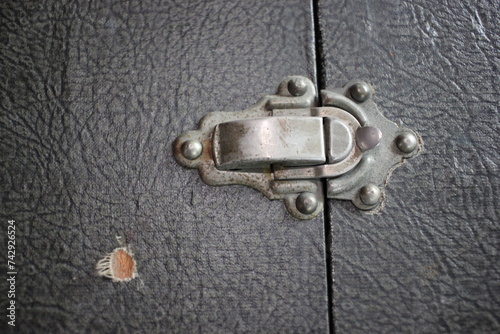 Old lock on a well travelled suitcase.