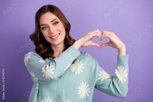 Photo of positive adorable lady dressed flower print cardigan showing arms hear smiling isolated violet color background