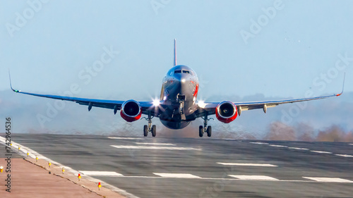 Landing at EMA G-JZBL photographed from the end of the runway in the sun.
