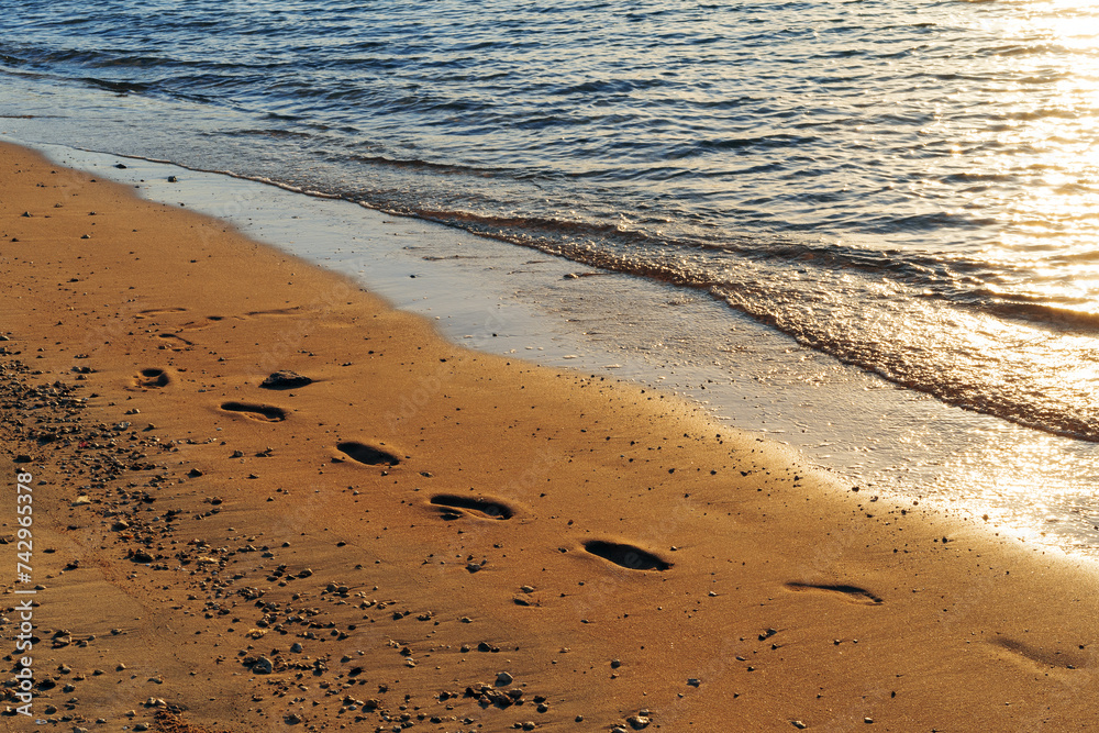 Human footprints in the sand. Shore of the Red Sea. Place for text. Human footprints in the sand. Shore of the Red Sea. Place for text.