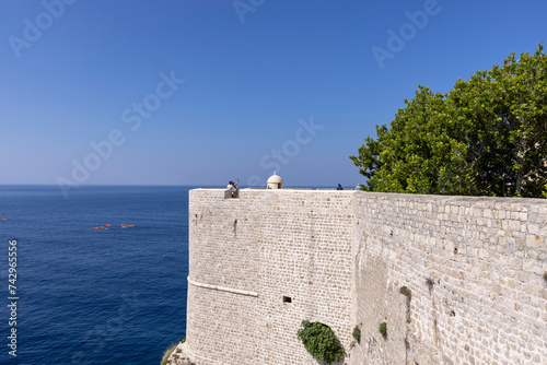 View of City Walls with one of towers, surrounding medieval city on the Adriatic Sea, Dubrovnik, Croatia photo