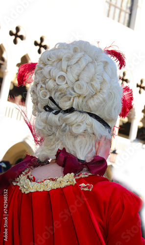 Photography white wig of the lady in mask during the Venice Carnival celebrations in Italy a
