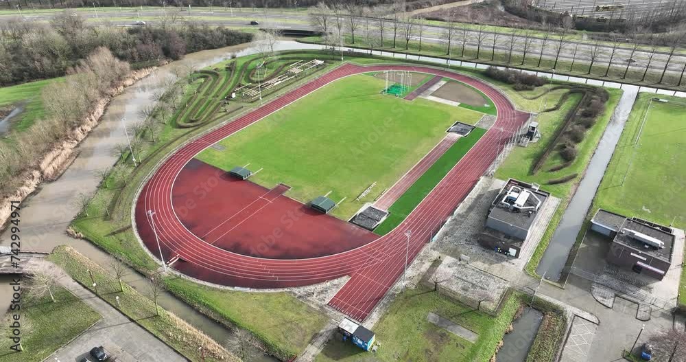 Birds eye aerial drone view of a running track, athletic course competion track. Field for excersise training and leisure activity. Outdoor sports arena Birds eye aerial drone view of a running track, athletic course competion track. Field for excersise training and leisure activity. Outdoor sports arena
