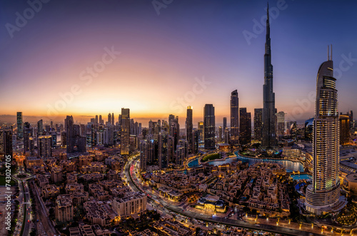 Panoramic view of the illuminated Downtown district skyline of Dubai, UAE, with the modern Skyscrapers and traditional buidings during dusk