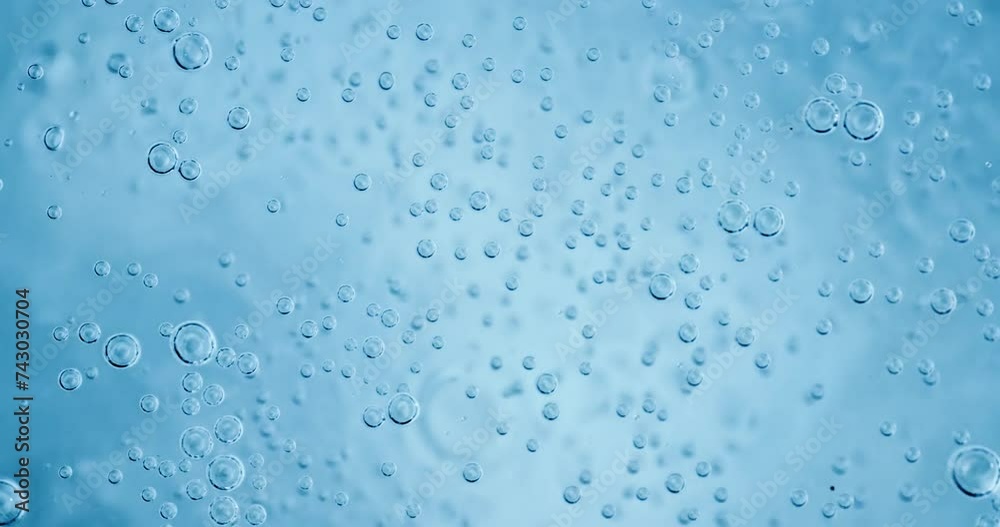 Oxygen bubbles in water on a blue abstract background on super slow motion. Oxygen bubbles in water on a blue abstract background on super slow motion.