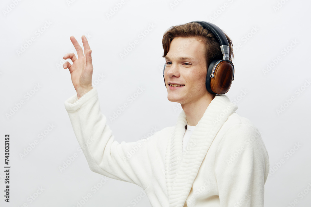 Modern Lifestyle: Handsome Caucasian Guy Enjoying Music with Wireless Headphones in Urban Setting Modern Lifestyle: Handsome Caucasian Guy Enjoying Music with Wireless Headphones in Urban Setting